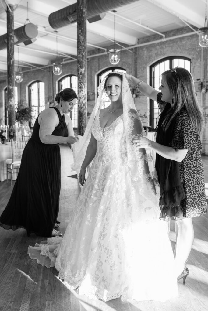 Cedar Room wedding pic of friends putting on the bride's veil