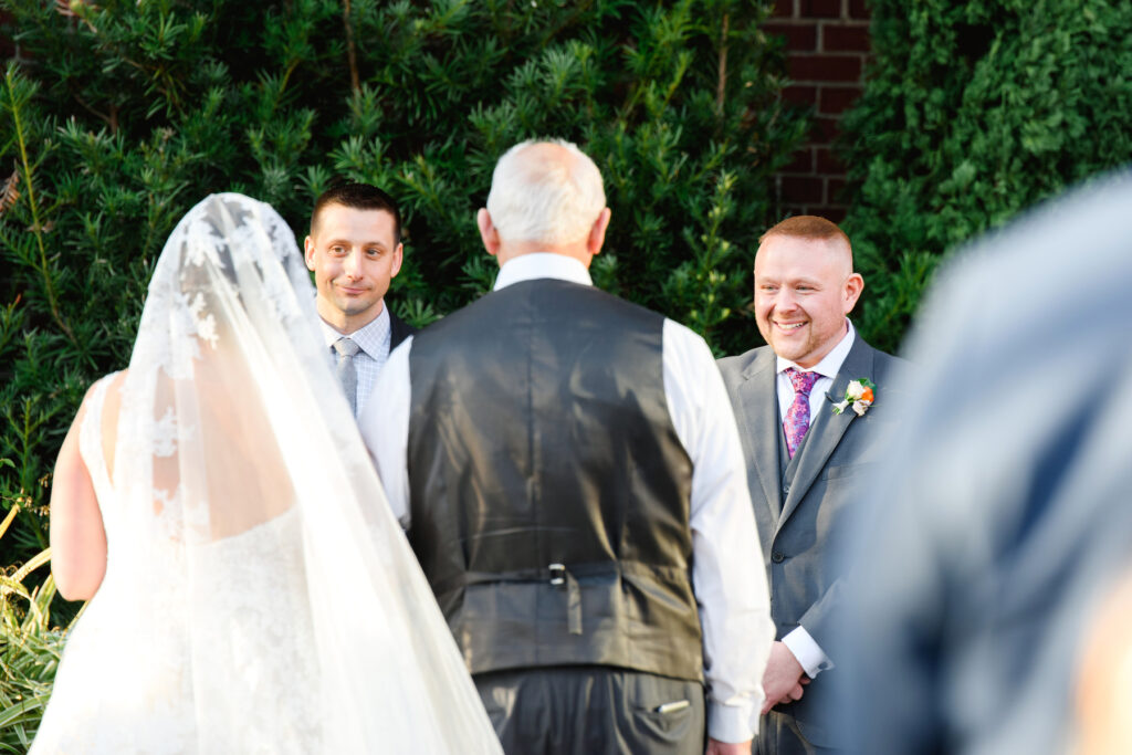 Cedar Room wedding of the groom watching the bride come down the aisle