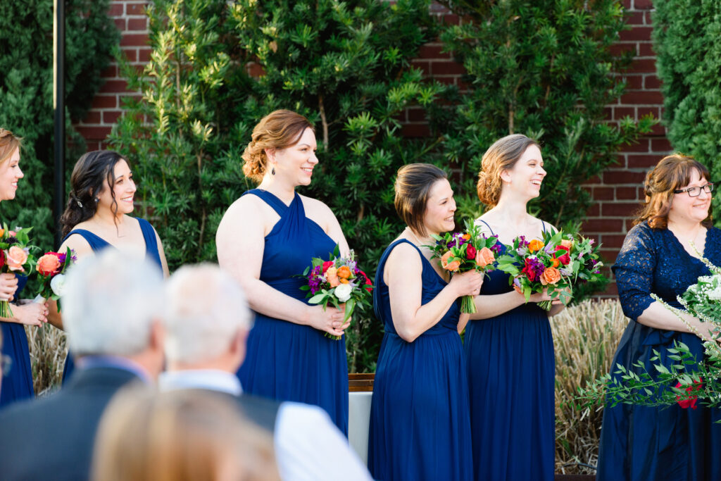 Cedar Room wedding bridesmaids looking at couple during ceremony