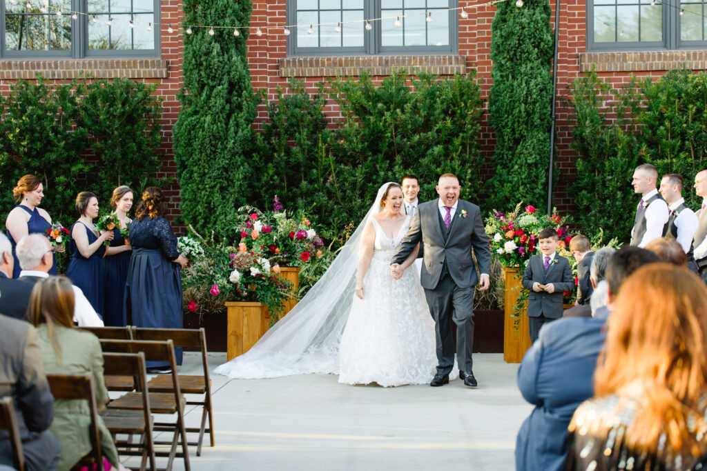 Cedar Room wedding of bride and groom walking up the aisle at the end of the ceremony