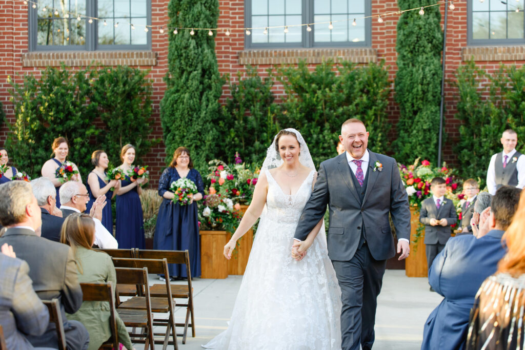 Cedar Room wedding of bride and groom walking up the aisle