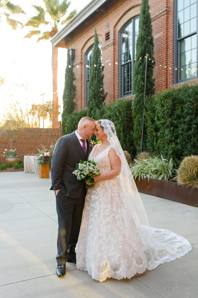 Cedar Room wedding of bride and groom posing for portrait in the courtyard