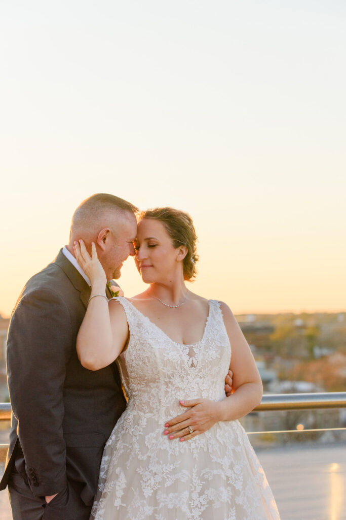 Cedar Room wedding rooftop couple portrait at sunset with bride holding groom's face