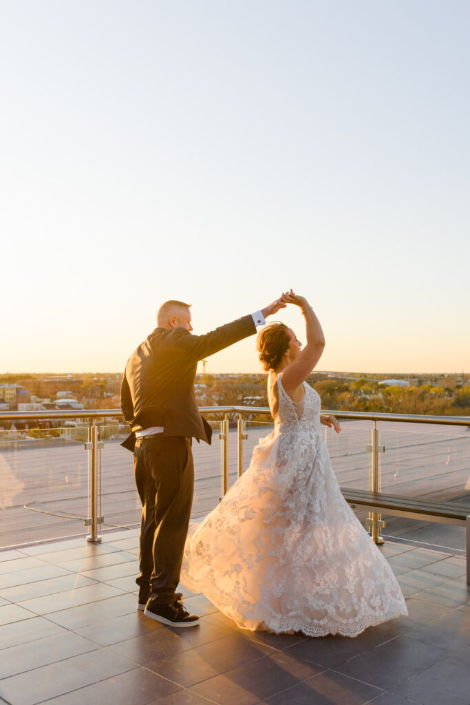 Cedar Room wedding rooftop portrait at sunset with groom twirling bride