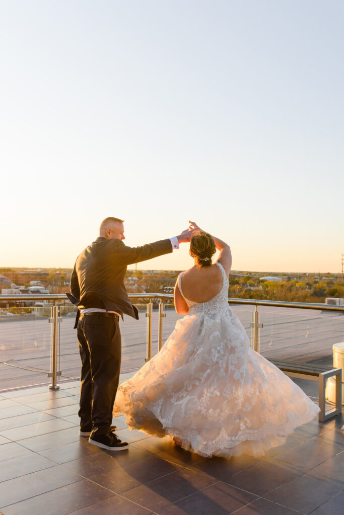 Cedar Room wedding rooftop portrait at sunset with couple dancing