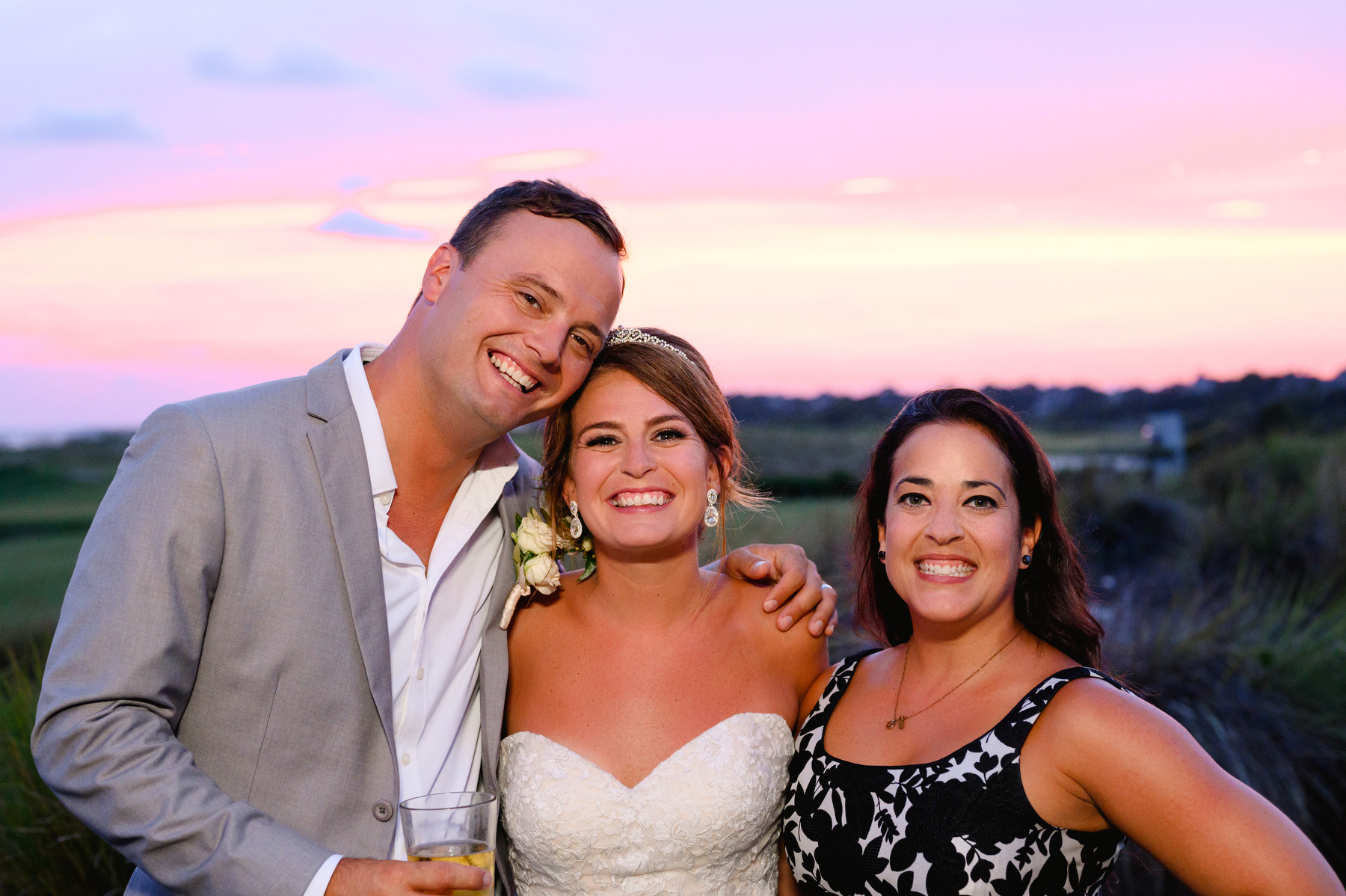 Charleston Wedding Planner Jessica with Cruz Coordination poses for a portrait with groom and bride