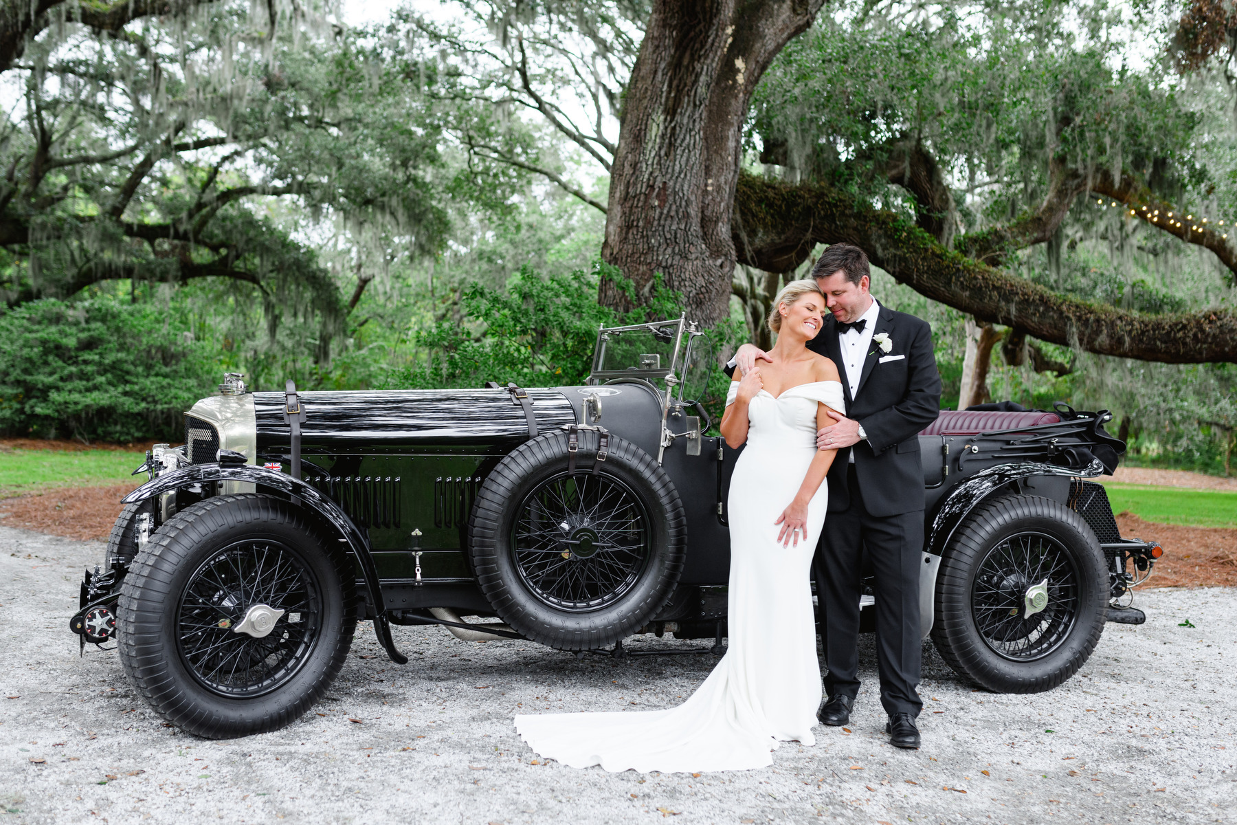 Bride and groom in front of a vintage car for a portrait at Wingate Place for their wedding