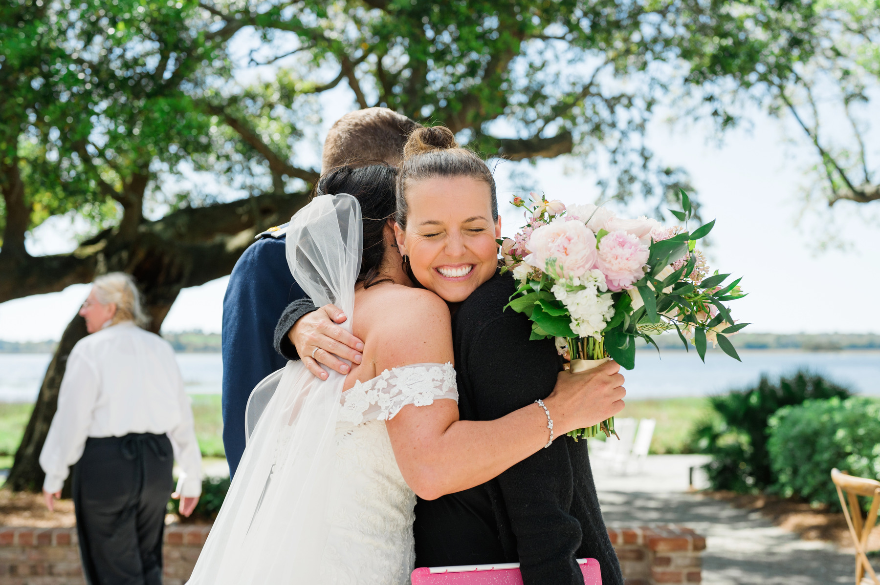 Charleston wedding planner Peper Events founder Erica Peper receiving a hug from a bride