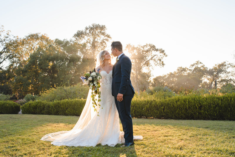 A bride and groom pose for a portrait during their Boone Hall wedding