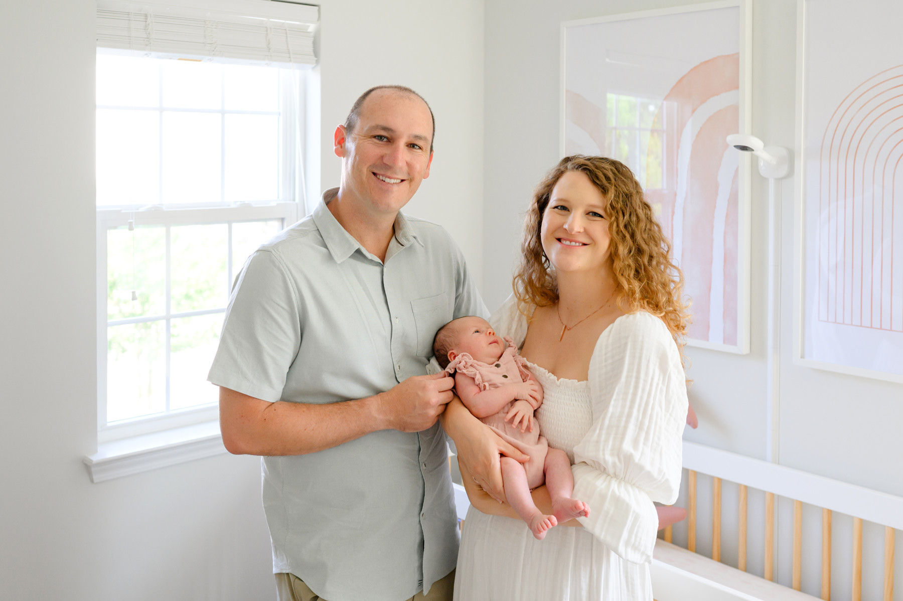 A new dad and mom pose with their newborn during their lifestyle newborn photos session in Charleston, SC.