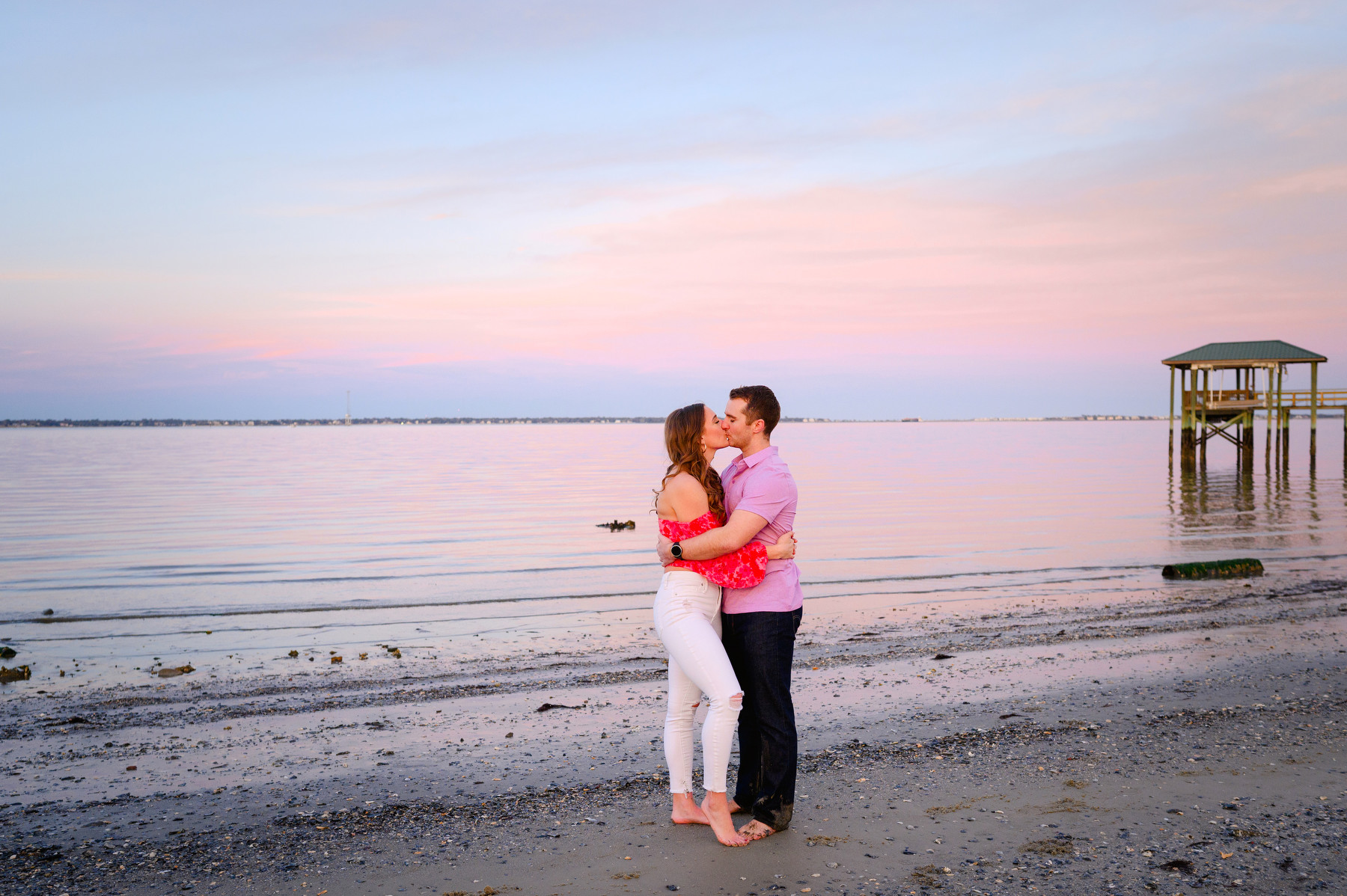 A woman and a man kiss during their Sunrise Park Engagement Photos session on James Island, SC.