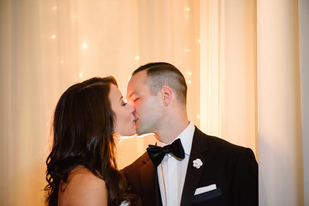 A bride and groom kiss after their Veritas Vineyard wedding ceremony.