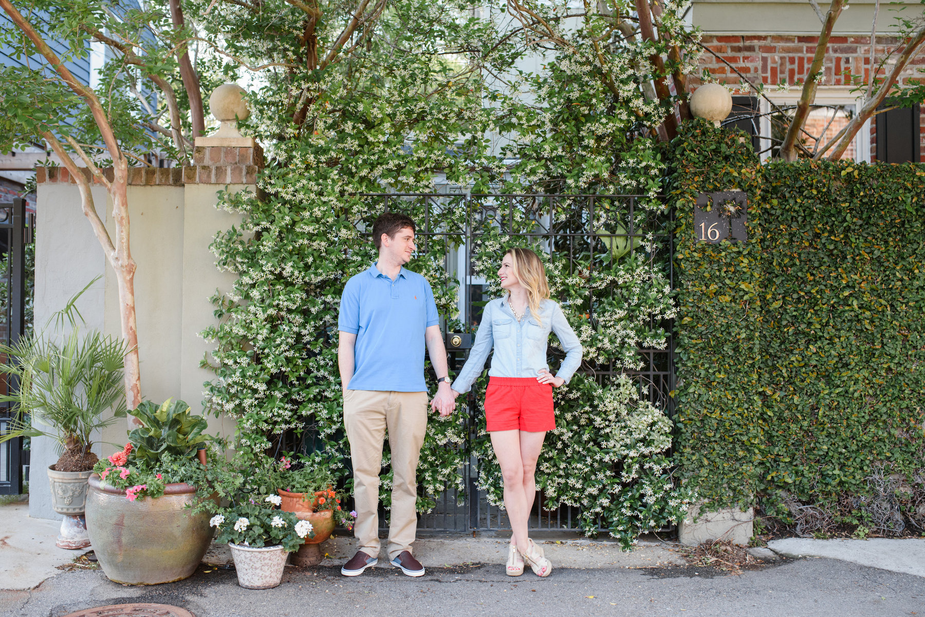 A man and woman pose during their Colonial Lake Park engagement photos in Charleston, SC