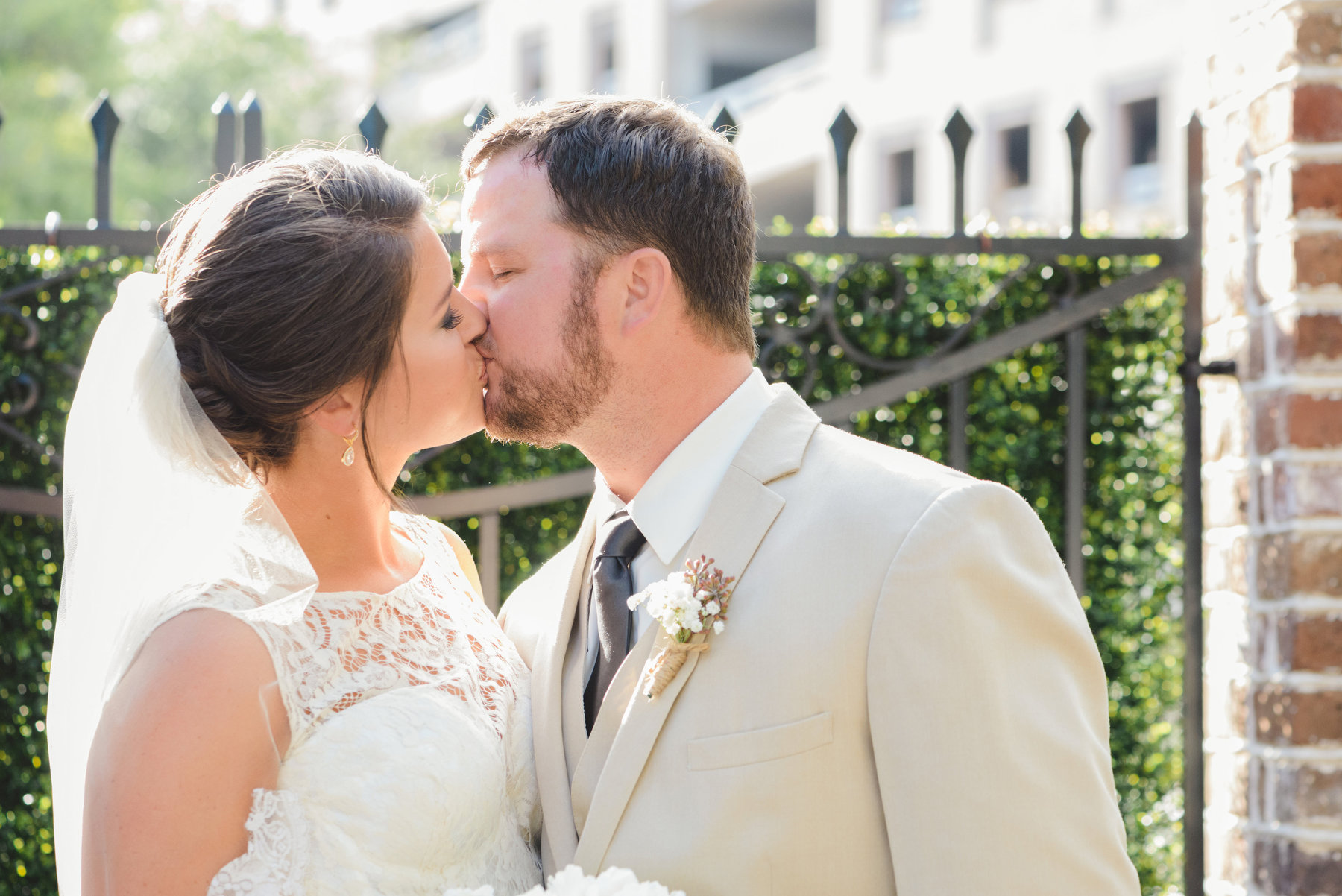 A bride and groom kiss for a portrait during their elegant fall wedding at the Gadsden House