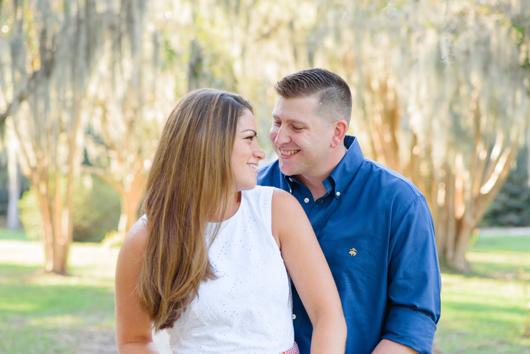 A woman and man pose for a photo during their Hampton Park engagement photography session.