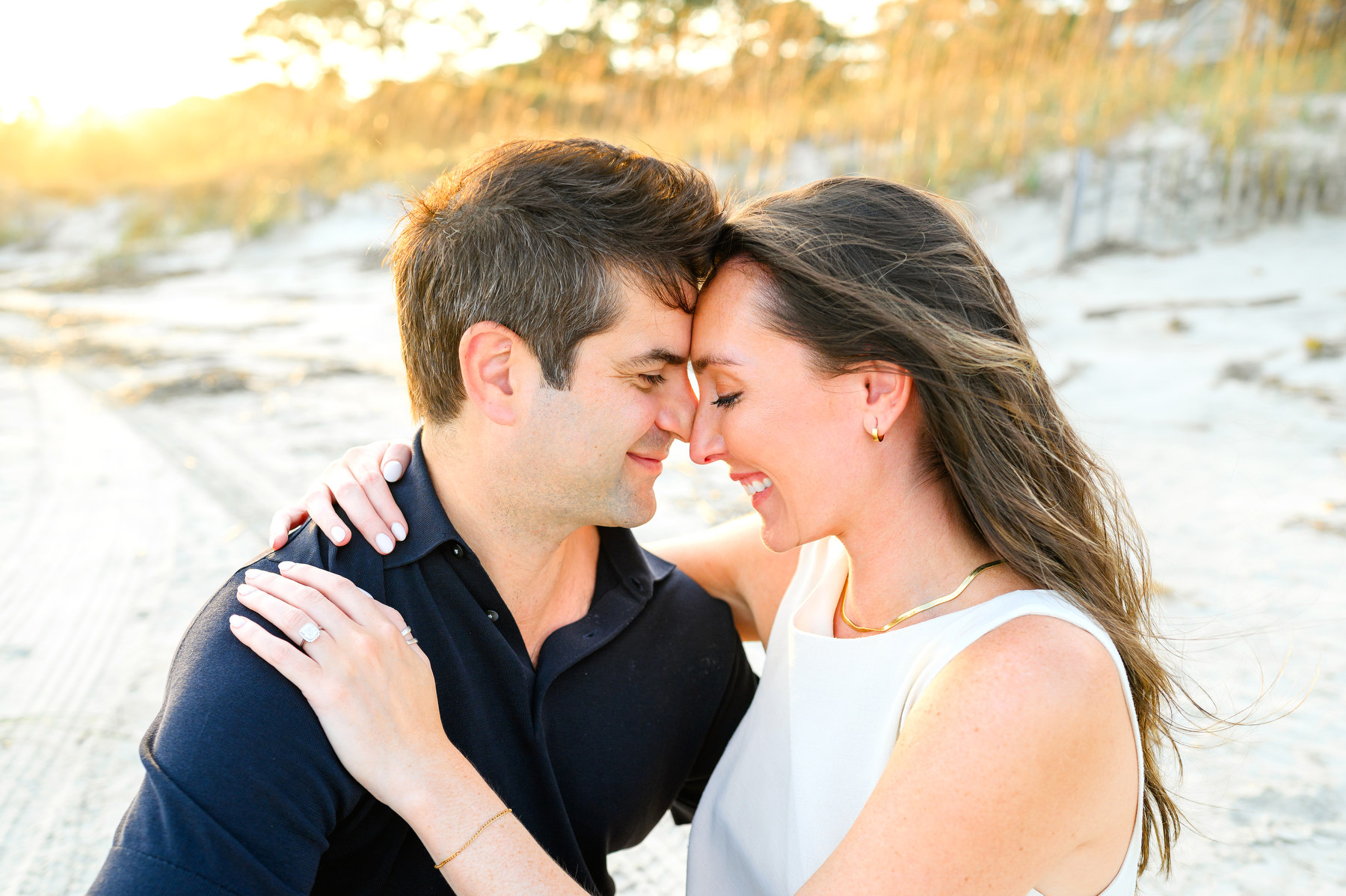 A man and woman nuzzle during their Hilton Head beach engagement session.