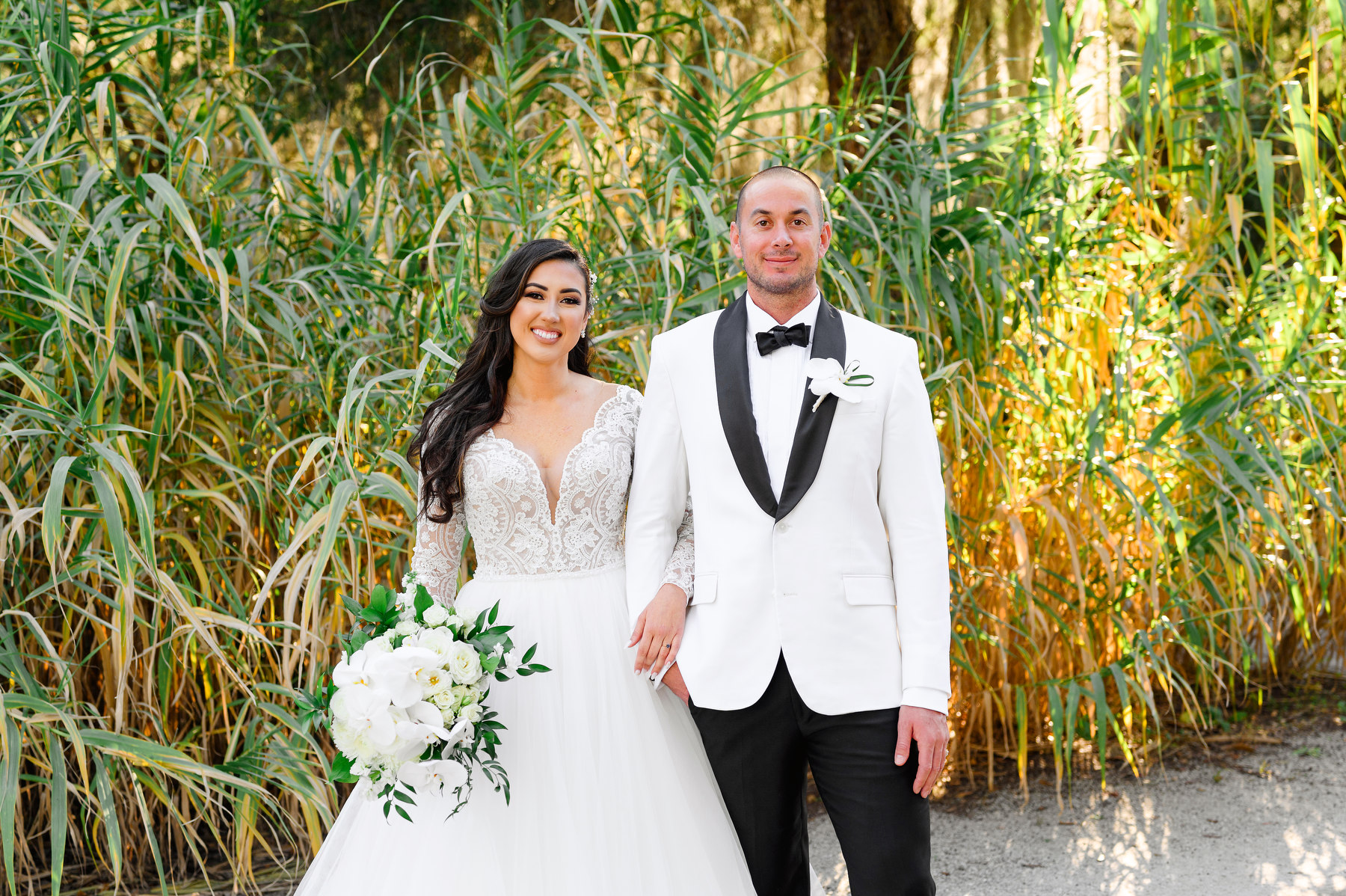 A bride and groom pose for a portrait during their winter Carriage House wedding in Charleston, SC.