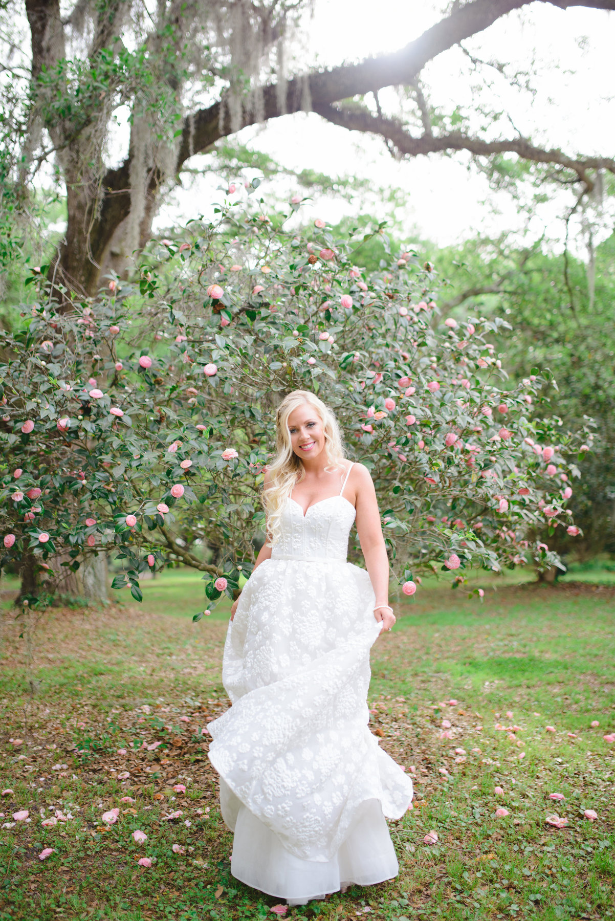 A bride poses during her spring Legare Waring House bridal photos in Charleston, SC.