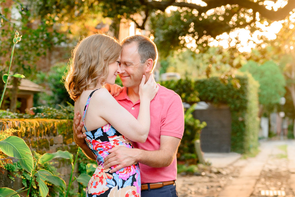 A woman and man pose for a portrait during their fall Charleston Battery engagement photos.