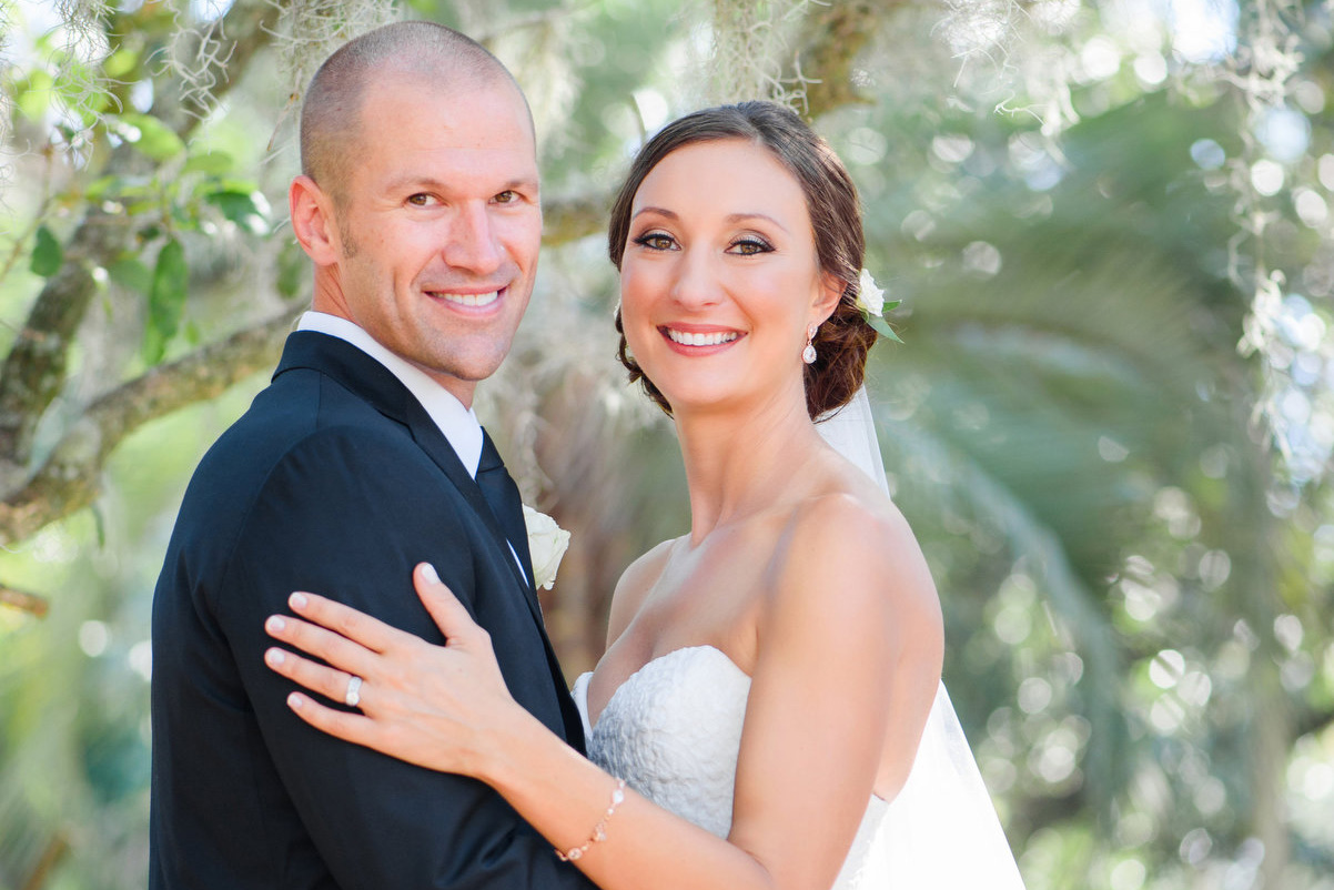 A groom and bride pose for a portrait during their Sonesta Resort Hilton Head wedding.