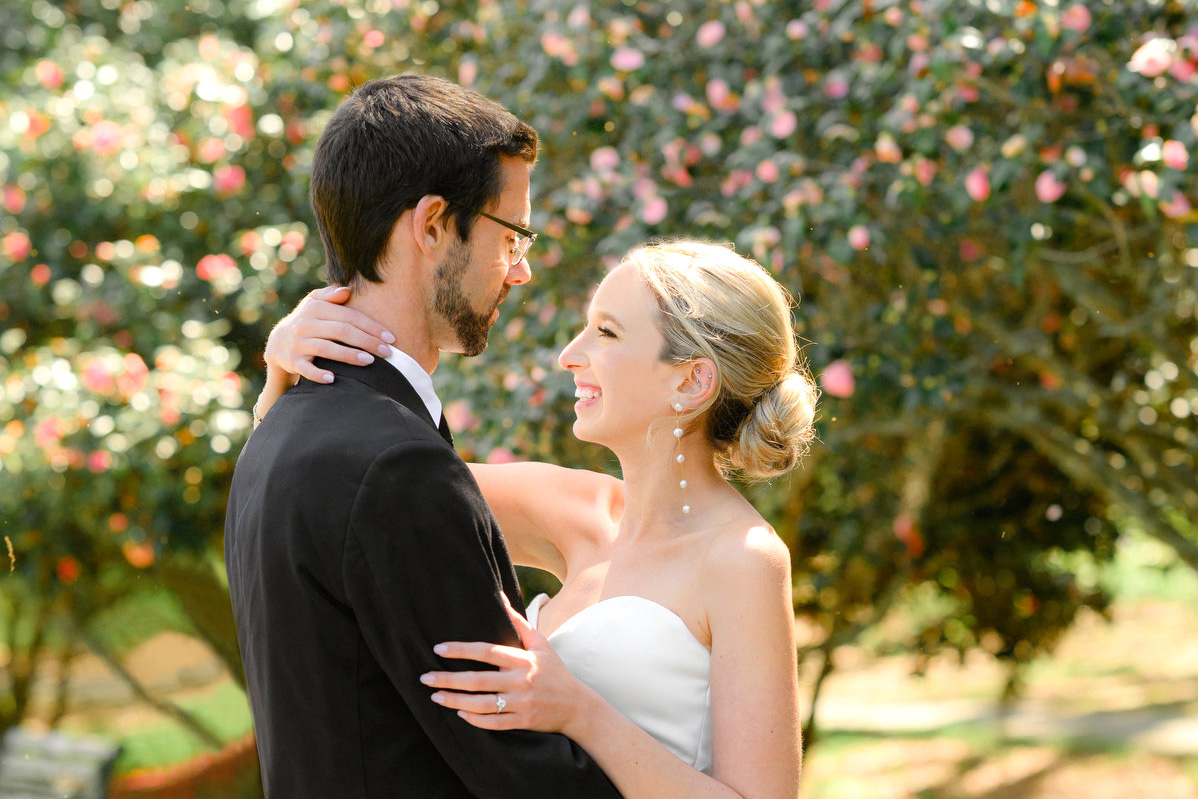 A groom and bride pose for a couple's portrait before their spring Francis Marion Hotel wedding in Charleston, SC.