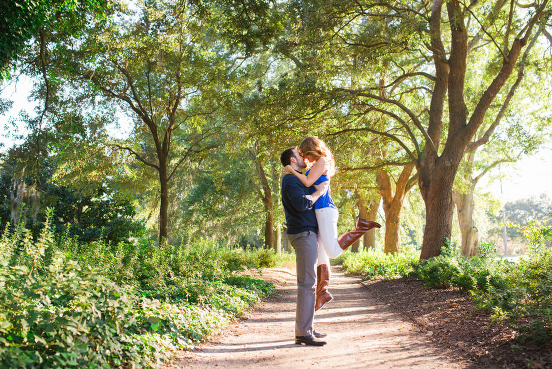 A couple pose for a portrait during their Fall engagement photos in historic downtown Charleston