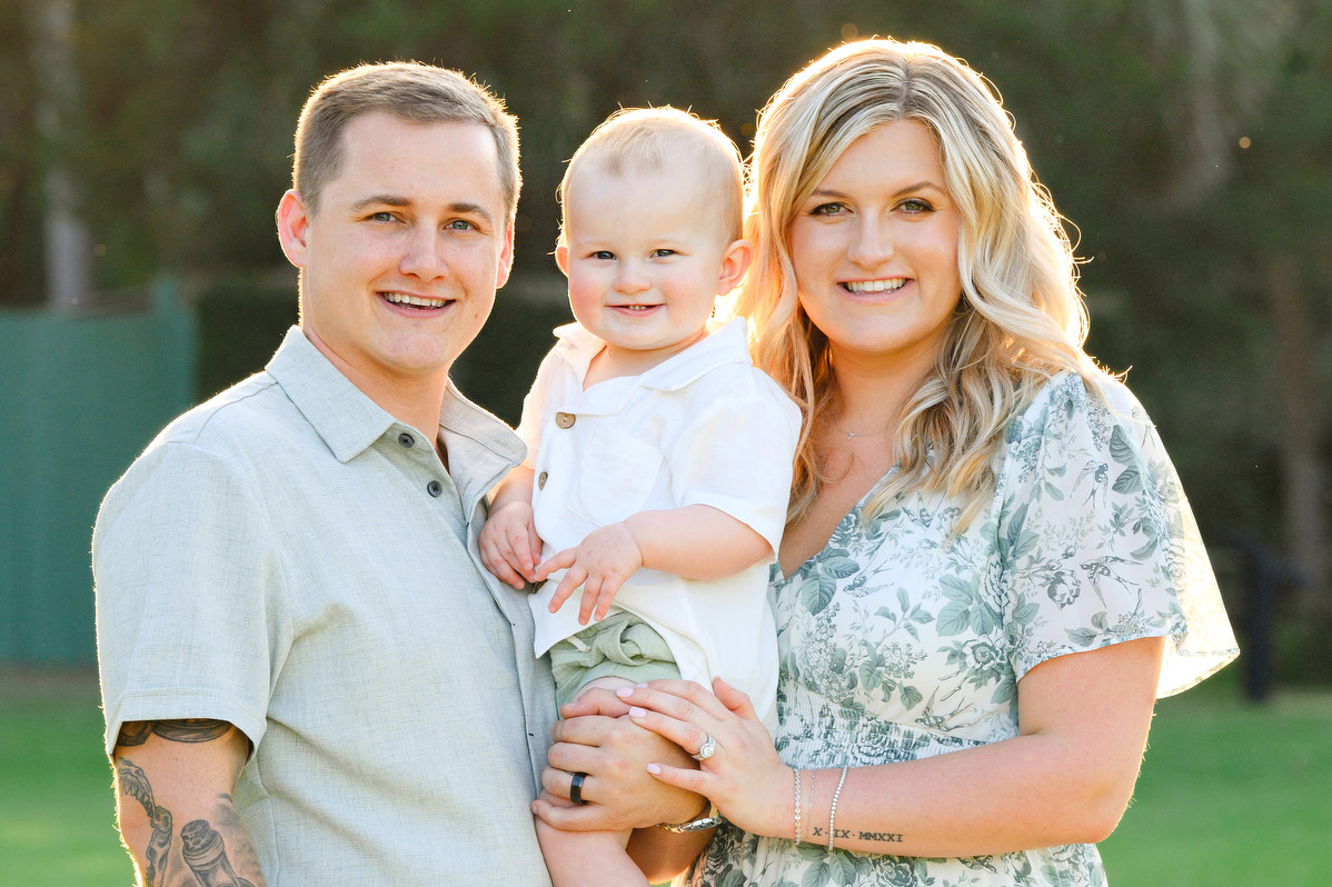 A family poses during fall beach family photos at Atalaya Castle.