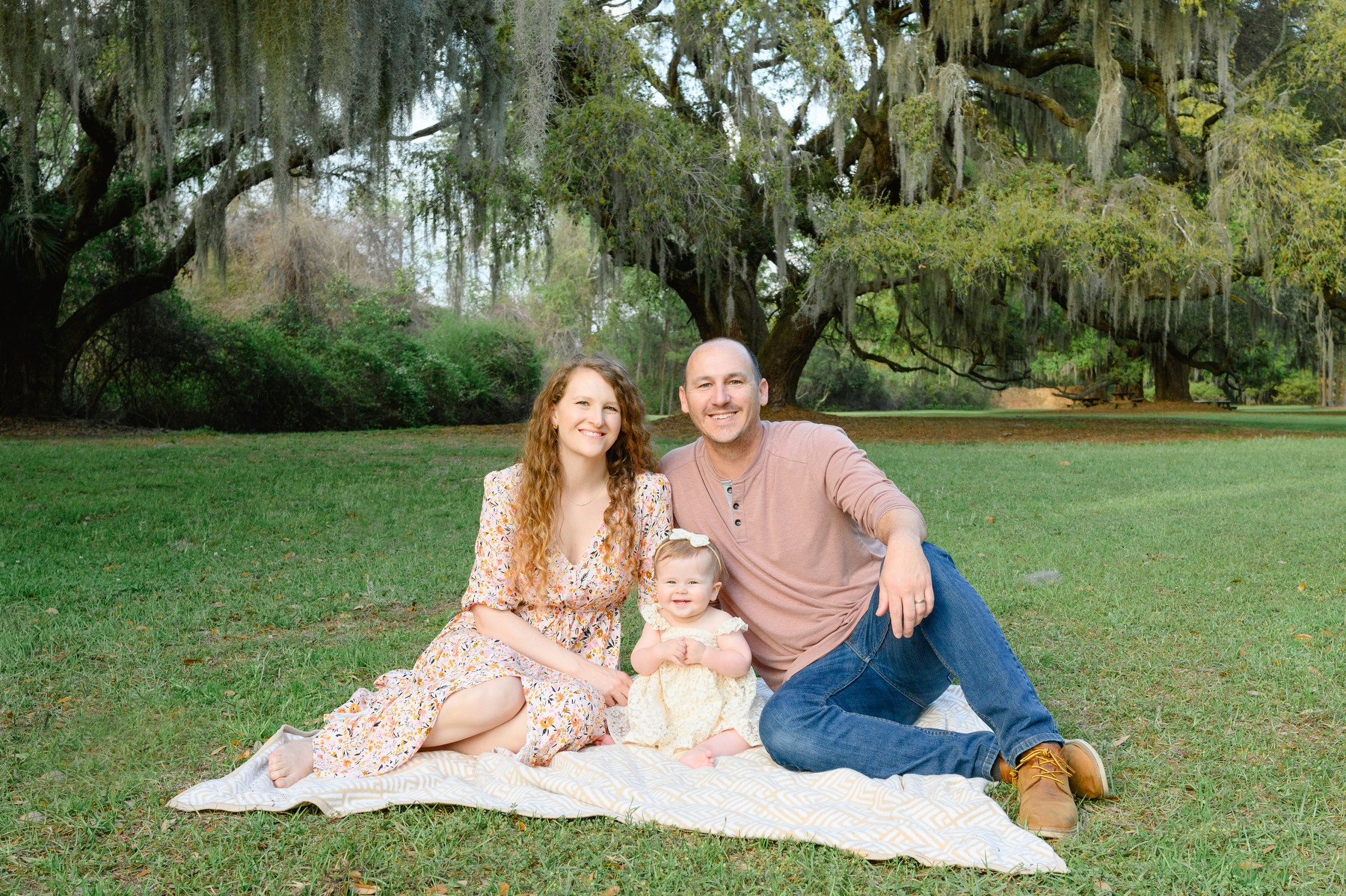 A mom, dad, and one-year-old daughter pose for a Johns Island Family photo