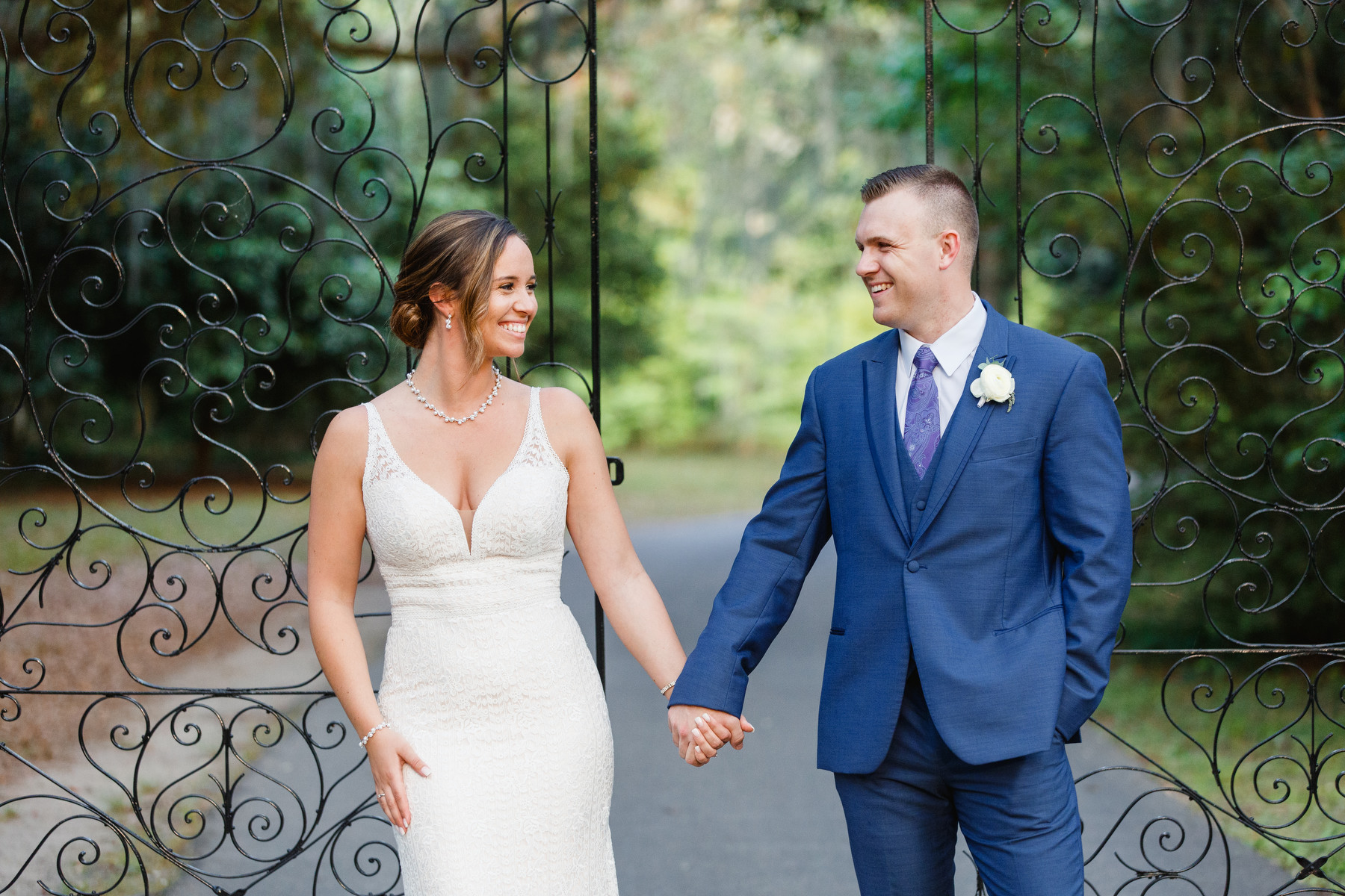 A bride and groom pose for a portrait at their Lavender and Navy Spring Legare Waring House Wedding