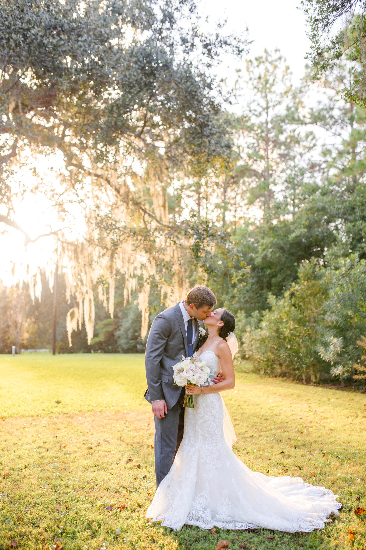 A groom and bride kiss for a photo at their traditional modern Charleston wedding